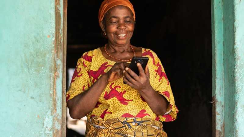 Woman recording qual video on phone in doorway